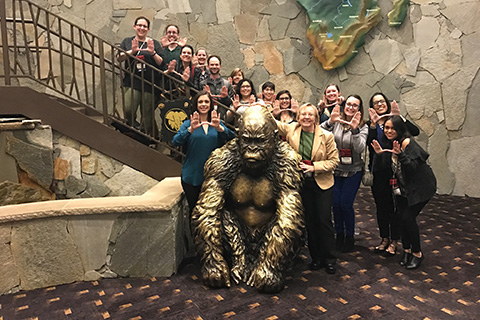 Music Therapy Faculty take a group picture behind a bronze gorilla
