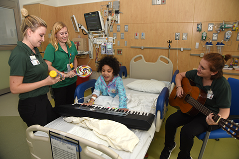 Music Therapy staff interact with patient